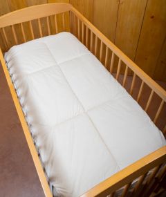 Surmatelas Douceur en laine pour lit bébé